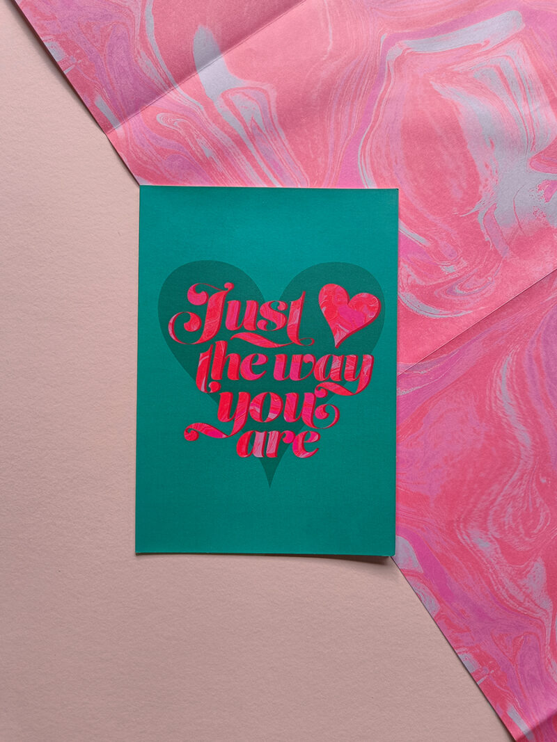 Just the way you are card on top of pink marble effect wrapping paper