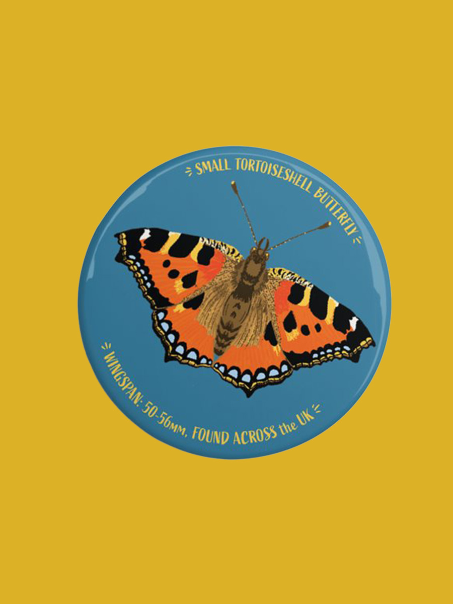 A round magnet with an illustration of small tortoiseshell butterfly.