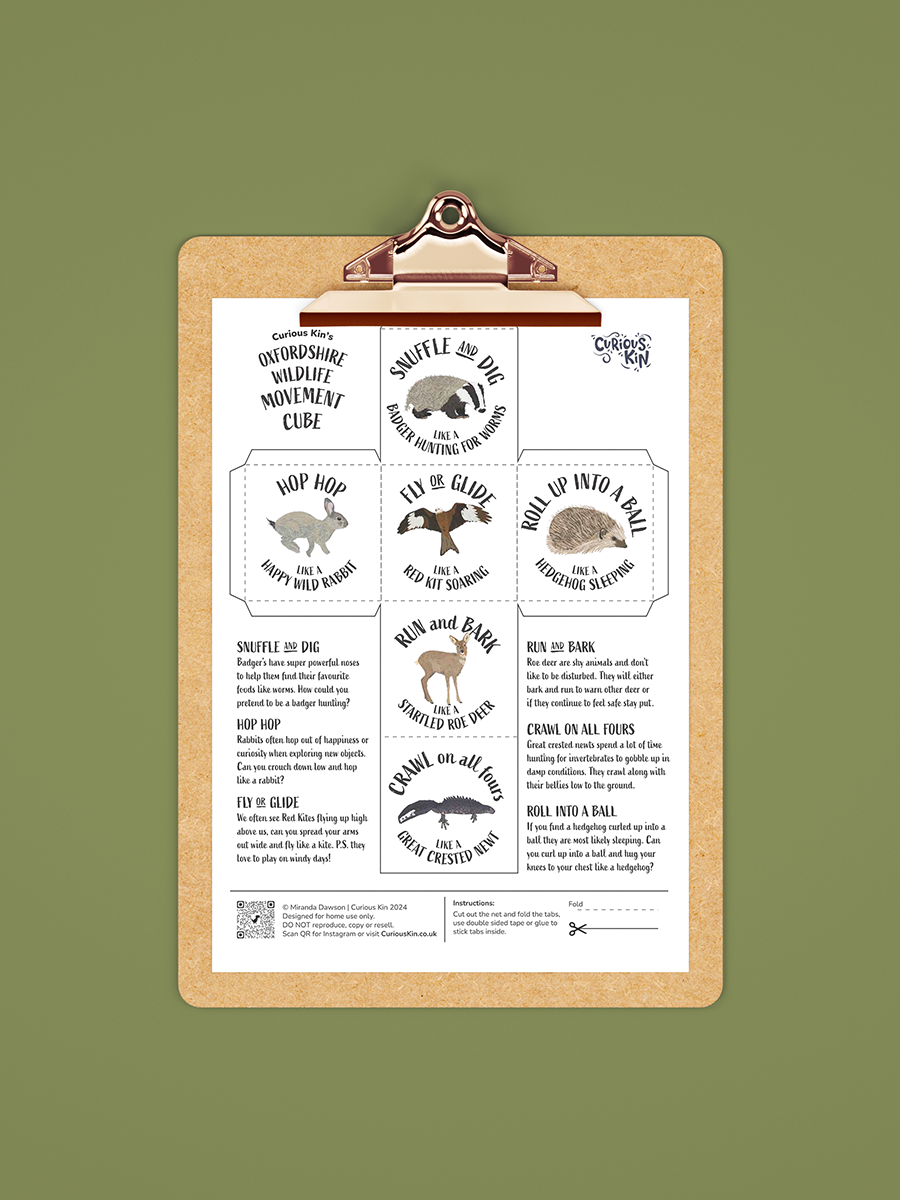 Oxfordshire Wildlife Movement Cube net printable with badger, red kit, great crested newt, roe deer, hedgehog and wild rabbit illustrations, on a clipboard