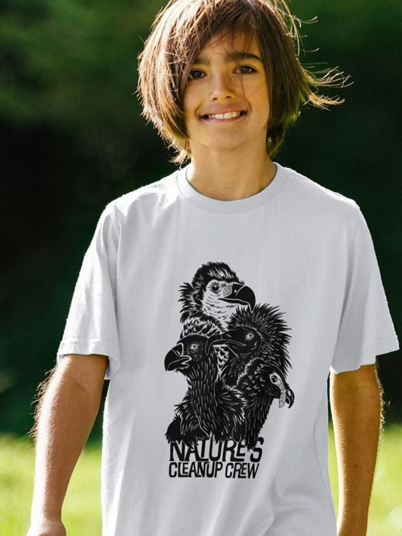 Boy wearing white t-shirt with Curious Kin's natures clean up vultures design printed on it