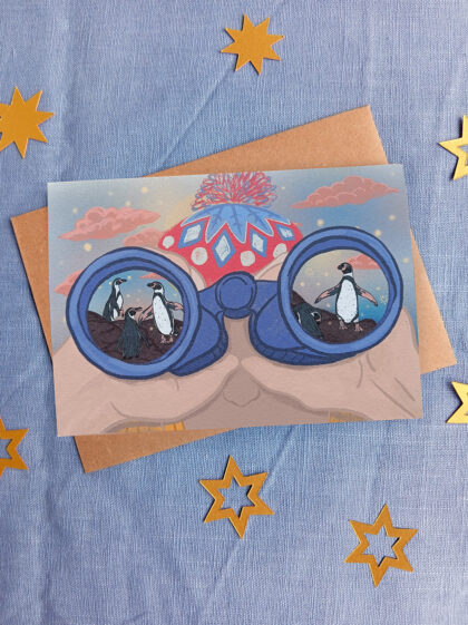 Illustrated Christmas card, woman looking through binoculars at humboldt penguins. Illustrated by Curious Kin, gold stars in background