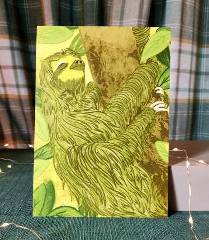 An A5 print of an illustration of a sloth in green mossy tones clinging to a tree asleep.
