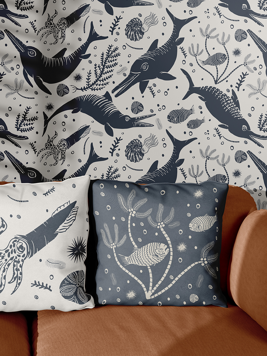 Living room showcasing Curious Kin's ancient tides icthyosaur pattern collection, with icthyosaur patterned wall, belmenite cushion and prehistoric fish printed cushion on orange sofa.