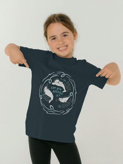Child pointing to their top with Curious Kin's what a beluga design printed on it