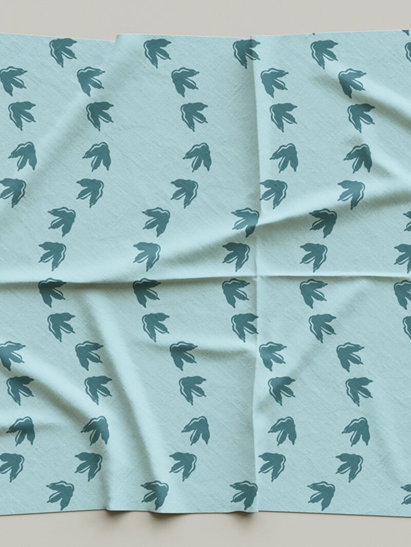 Fabric sample of Curious Kin's dino footprints pattern