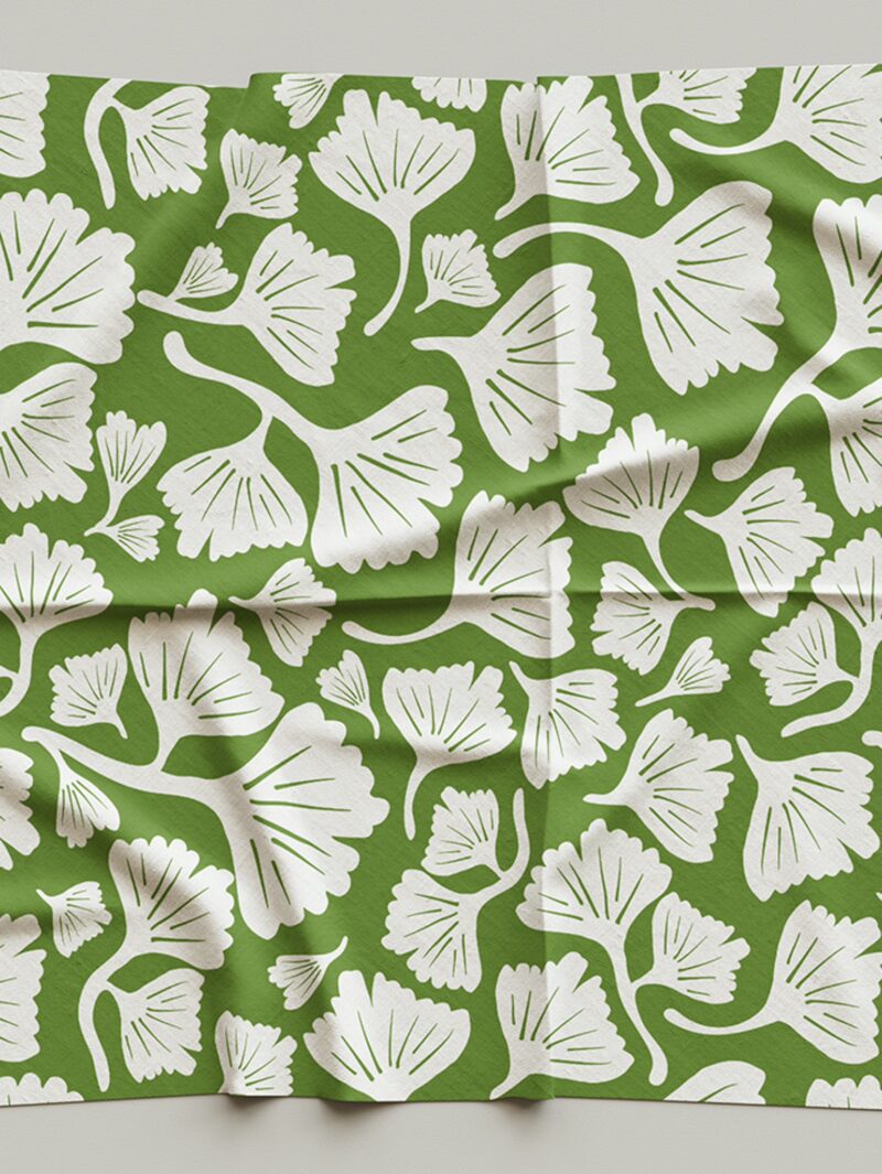 Fabric sample of Curious Kin's of ginkgo leaves in green and white