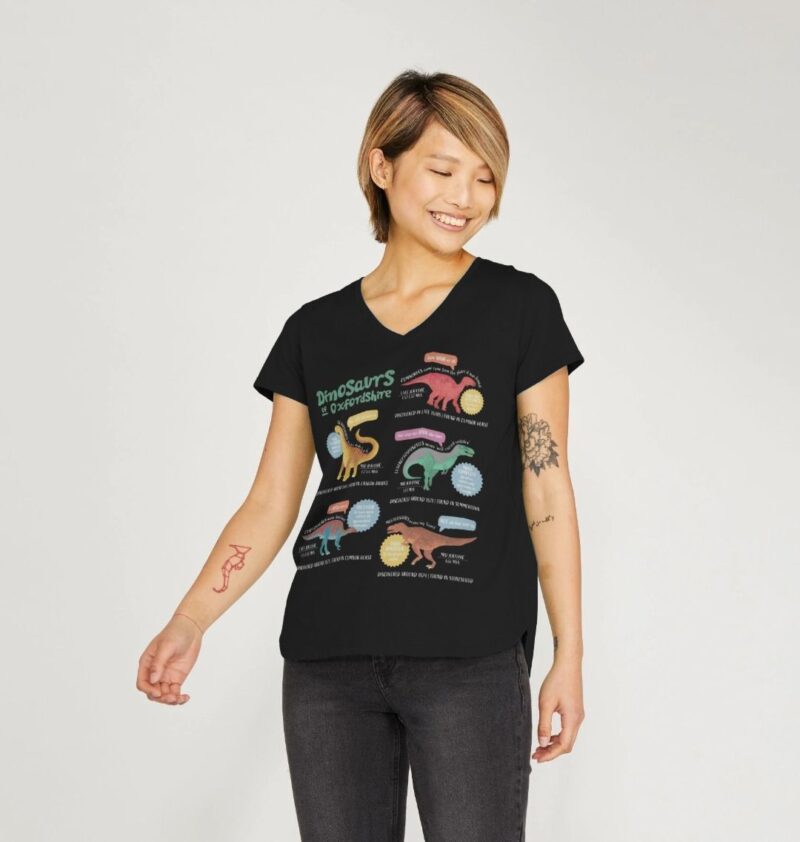 Women wearing a black v neck tshirt with curious kins dinosaurs of oxfordshire fun fact design printed on it