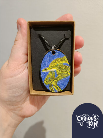 Curious Kin's ornate flying snake wooden necklace pendant