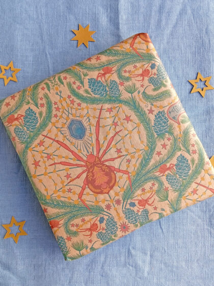 Gift wrapped in Christmas spider gift wrap illustrated by Curious Kin, printed by Planet wrap it