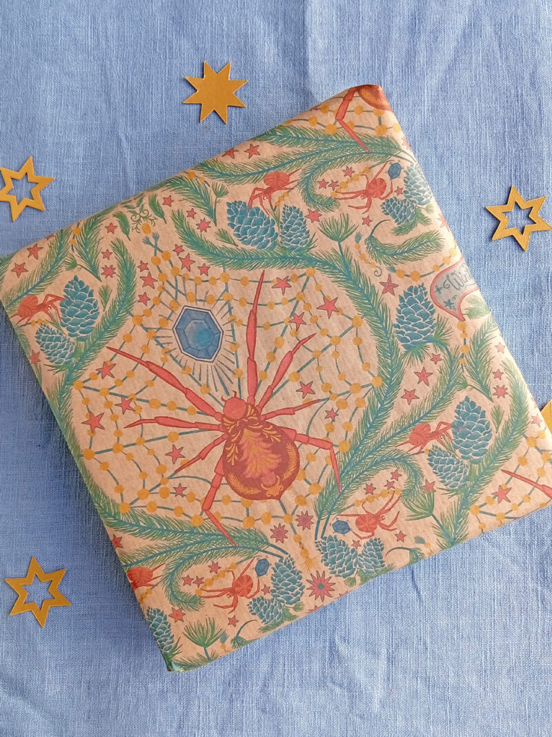 Gift wrapped in Christmas spider gift wrap illustrated by Curious Kin, printed by Planet wrap it