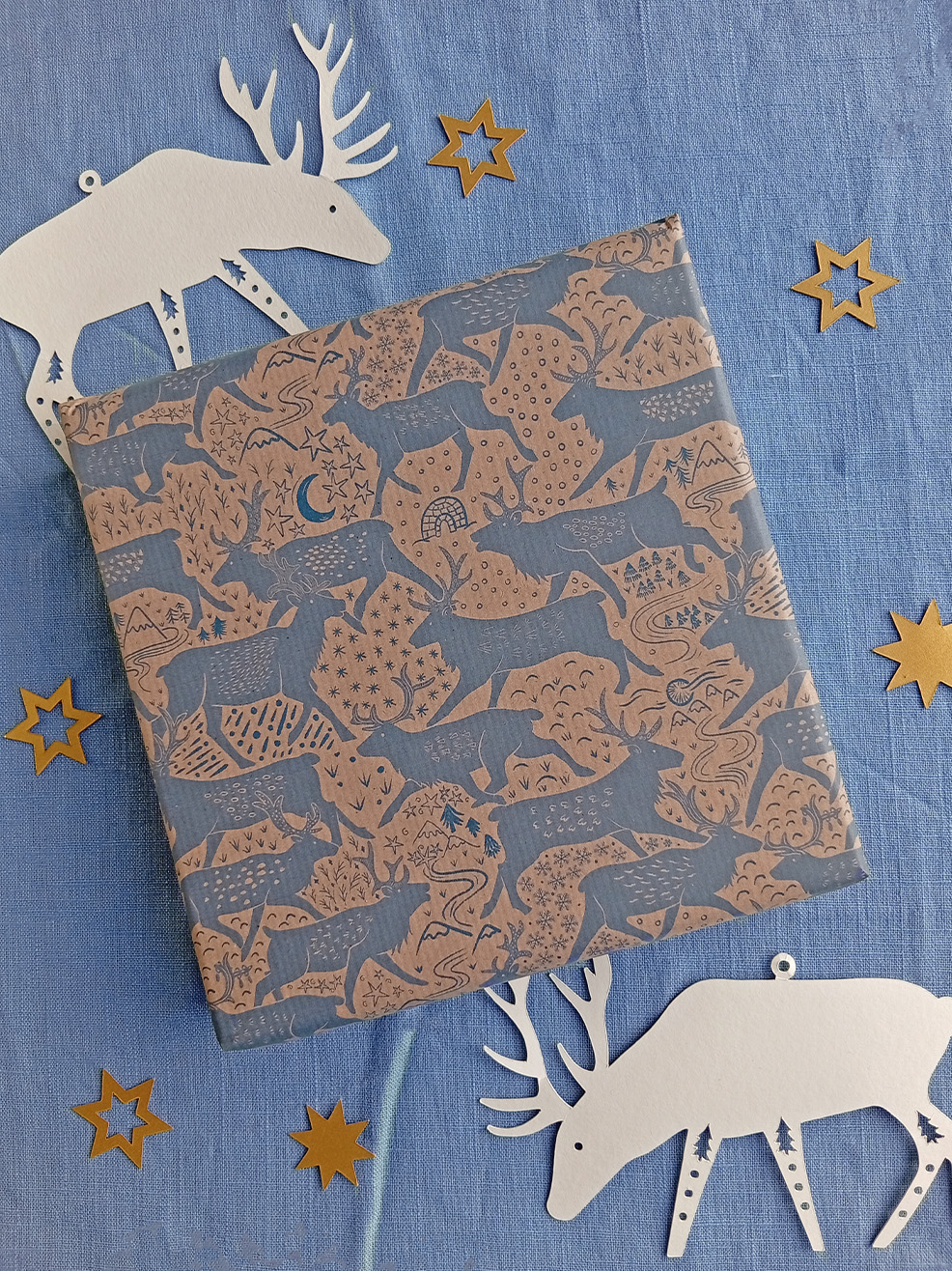 Recycled wrapping paper with reindeer pattern designed by Curious Kin