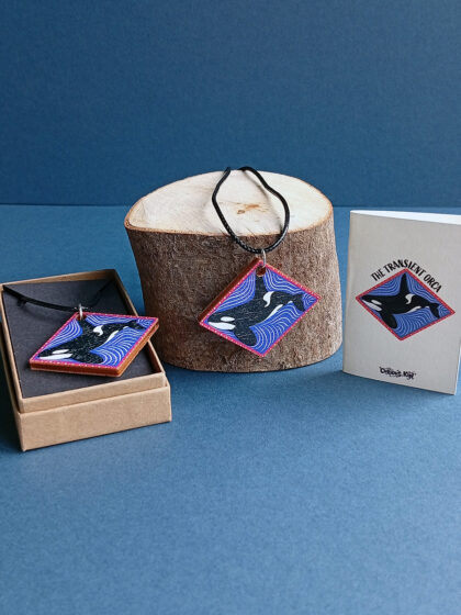 UV printed diamond wooden pendant with illustration of an Orca and a waxed cotton cord, mini card and kraft jewellery box with black card liner.