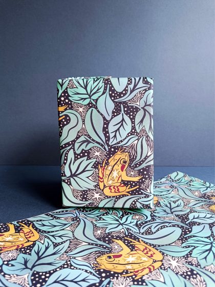 Gift wrapped in alaskan wood frog and frosted leaf litter luxury gift wrap and sheet of gift wrap