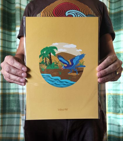 Yellow a4 print with illustration of a blue archeopteryx dinosaur on sandy beach with palm trees.