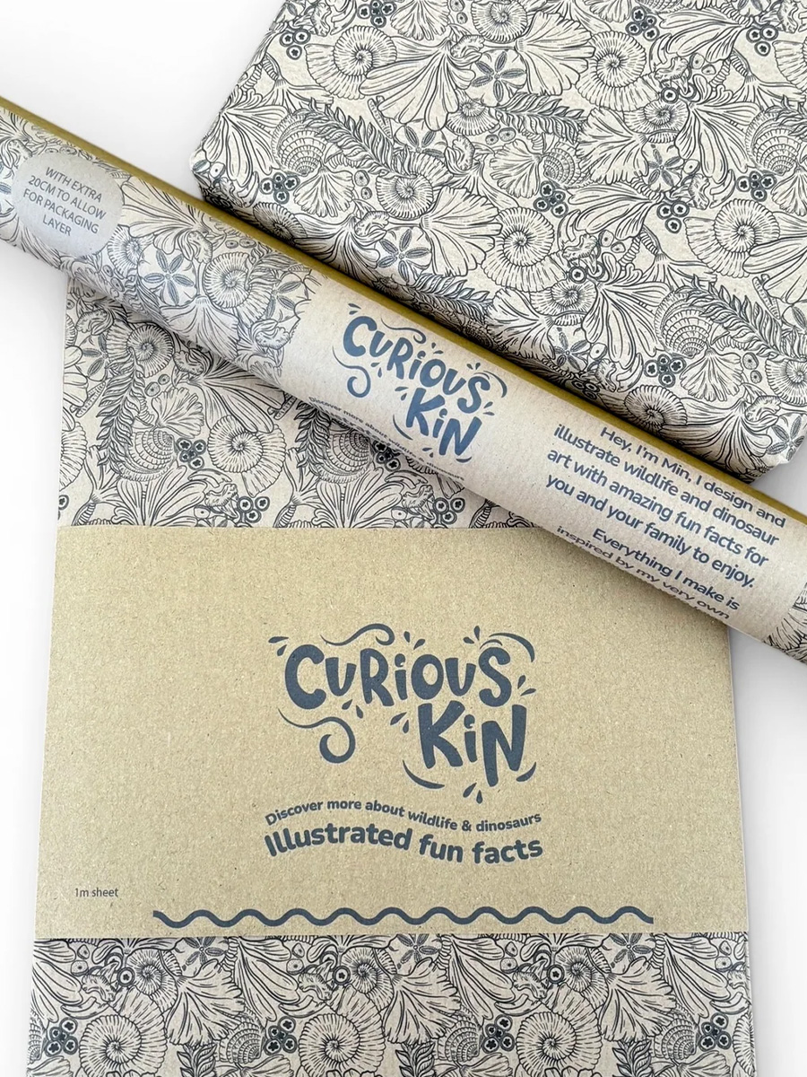 Hand drawn repeating fossils line pattern printed on kraft paper. Shown as folded sheet, roll and gift wrapped.