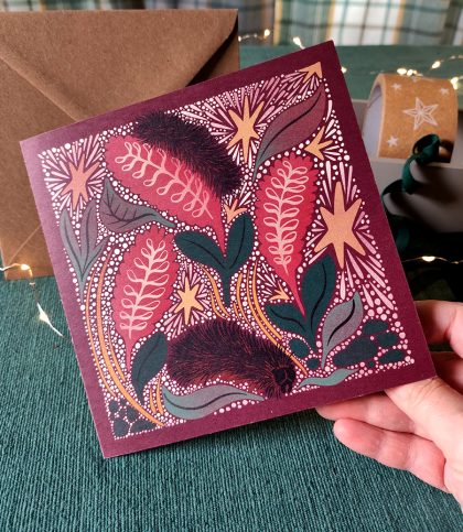hand holding square card with Arctic woolly bear caterpillars and stars card