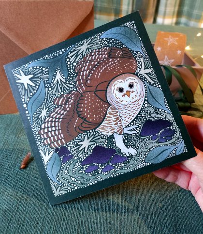 hand holding square card with Alaskan Barred owl and stars card
