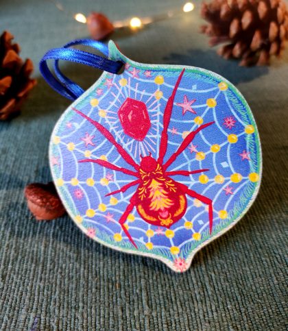 A Christmas spider wooden tree decoration with ribbon tie in red and blue.