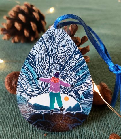 Pear shaped wooden decoration of female explorer in ice cave
