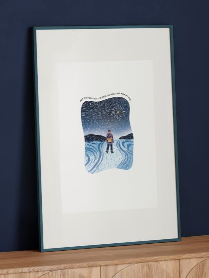 A3 framed art of a woman explorer standing in a snowstorm looking up a bright large star with original quote.