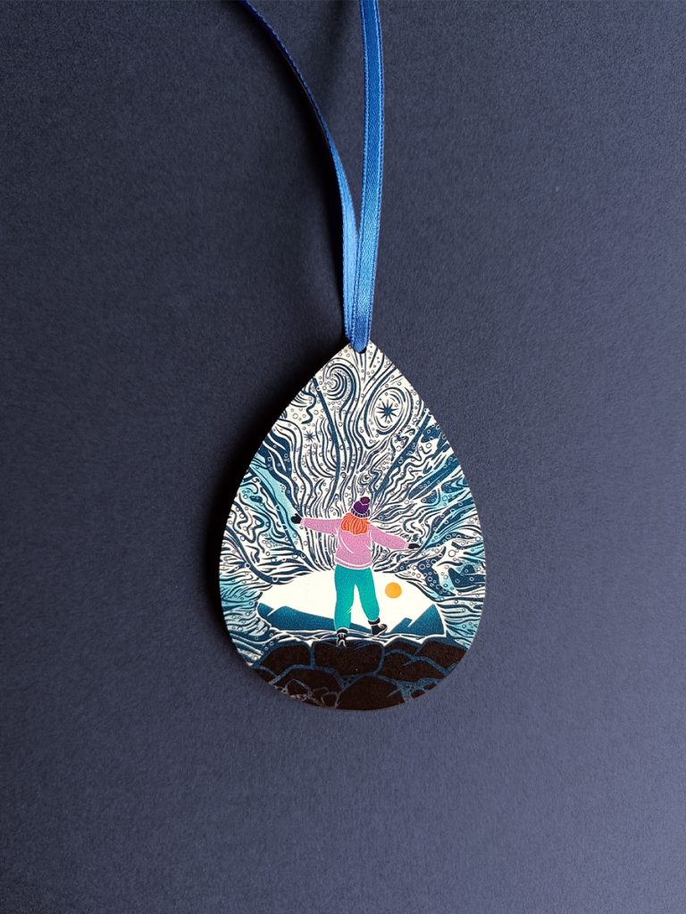 Pear shaped wooden decoration of female explorer in ice cave