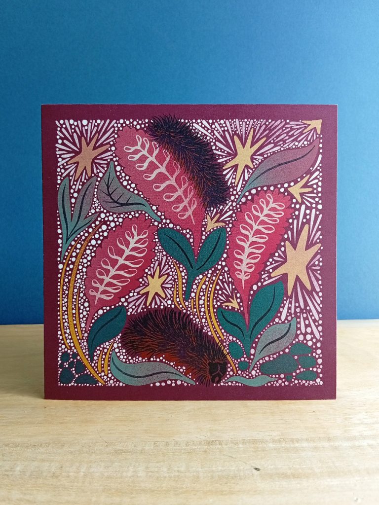 Square linocut inspired illustrated card of alaskan woolly bear caterpillar surrounded by stars.