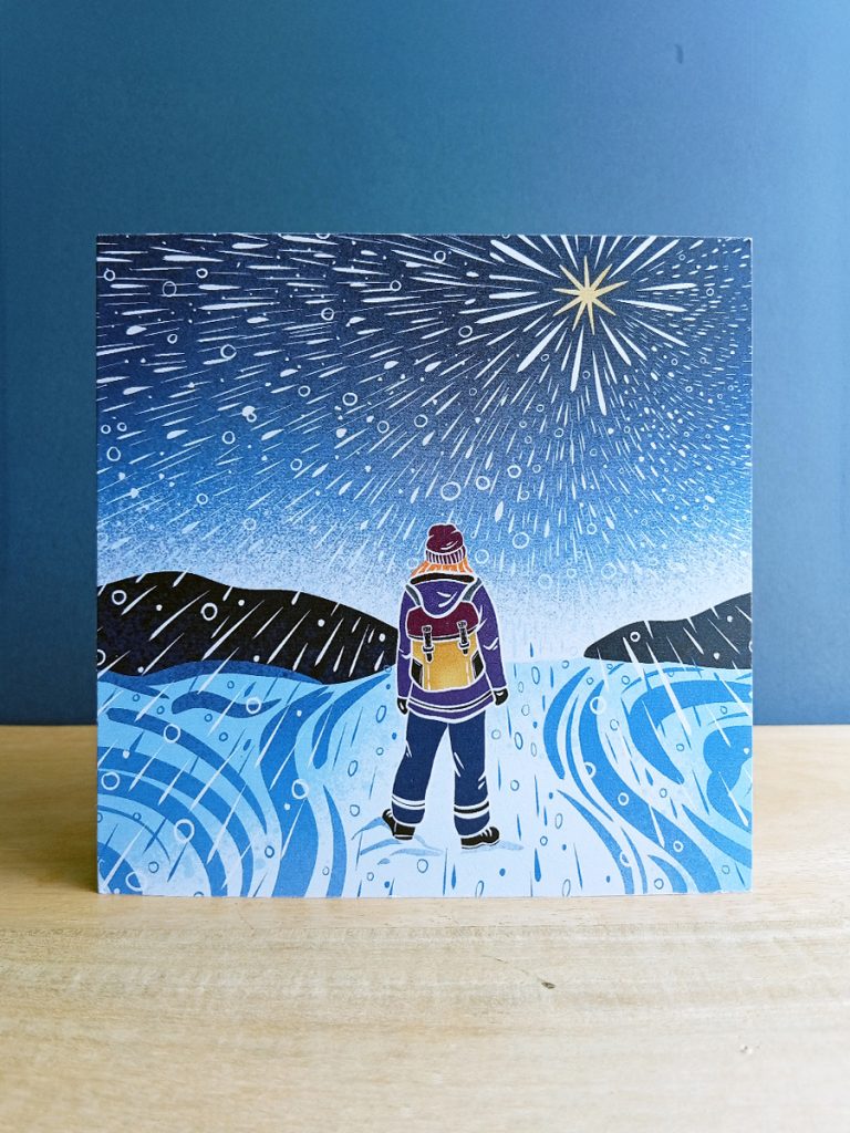 Illustration of a female explorer walking through snow storm with star above printed on square card.