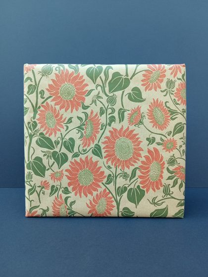 Gift wrapped in hand drawn sunflowers recycled wrapping paper in green and orange tones.