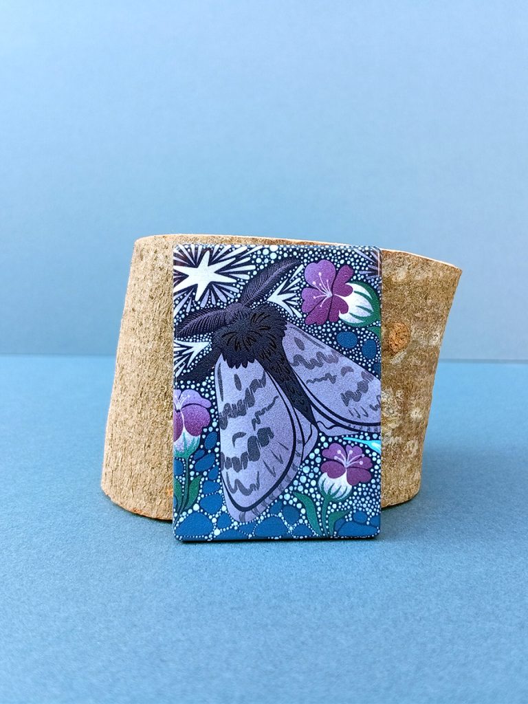 Rectangular magnet with arctic woolly bear moth artwork from frost keepers collection
