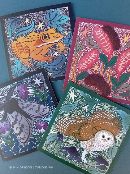4 illustrated square cards: alaskan wood frog, arctic woolly bear caterpillar and moth, barred owl in complementing jewel colours surrounded by native plants, rocks and frosted stars in a linocut style.